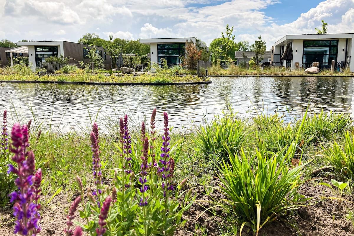 A modern building with a reflective water feature in front.