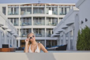 A modern cruise ship with a multi-level structure, balconies, and a pool area. - The Privilege Hotel Ezra Beach Club (Koh Samui)