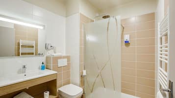 A modern bathroom with a sink, toilet, and shower.