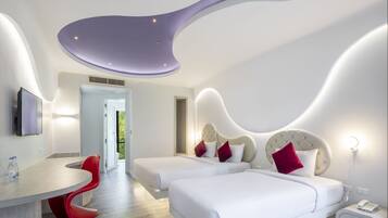 A modern bedroom with two beds, a desk, and a red chair.