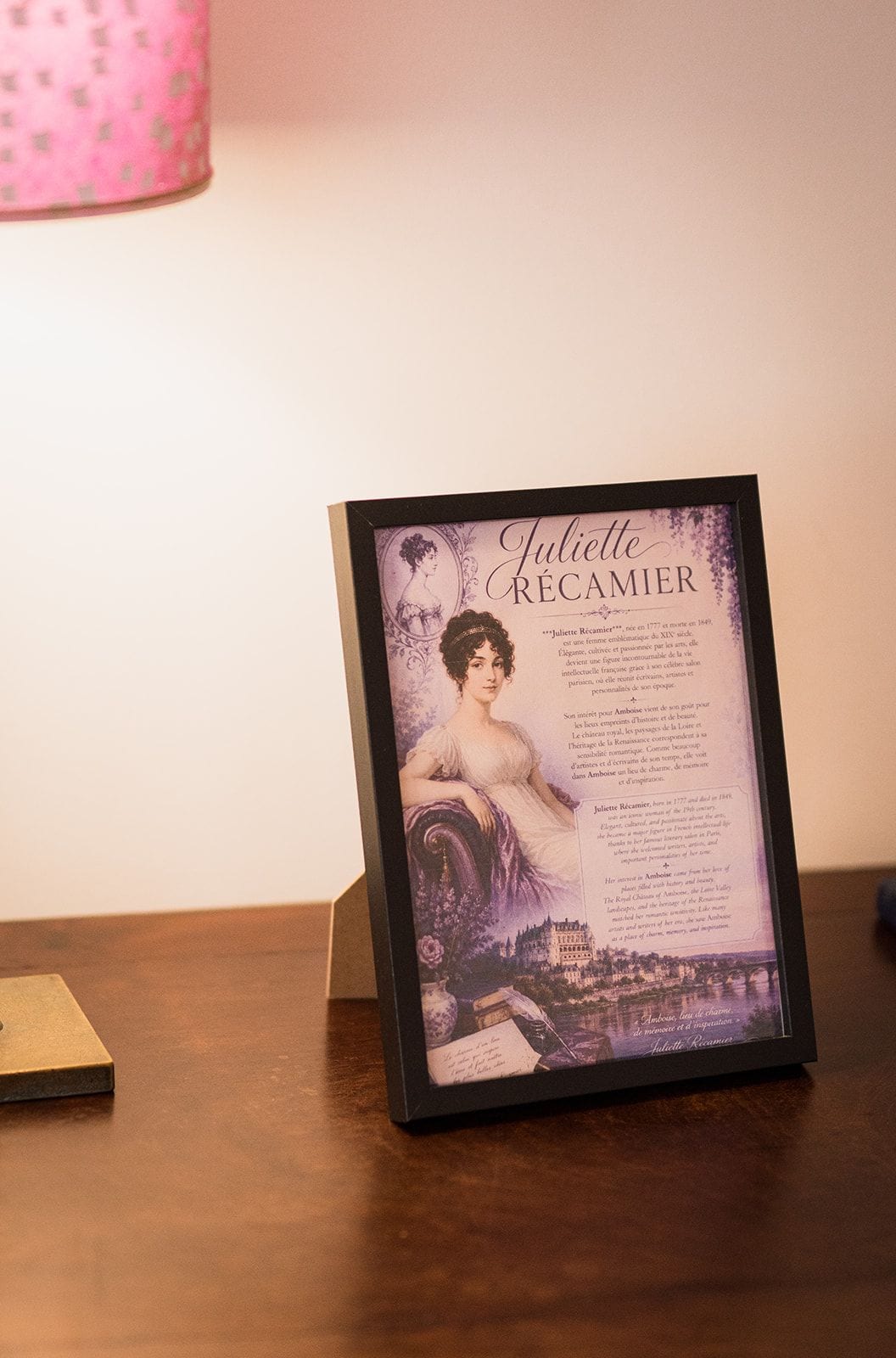 A framed picture of Juliette Récamier on a wooden surface.