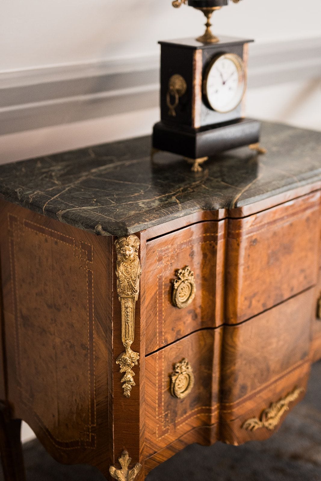 A wooden chest with intricate carvings and brass handles.