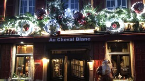 The exterior of Au Cheval Blanc hotel with Christmas decorations, including wreaths and lights. - Au Cheval Blanc Hôtel et Restaurant (Ribeauvillé)