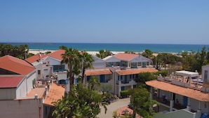 A coastal hotel with multiple buildings, a beach view, and a clear sky. - Le Dune Sicily Hotel (Catania)