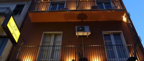 Vista frontal de la propiedad por la tarde o noche