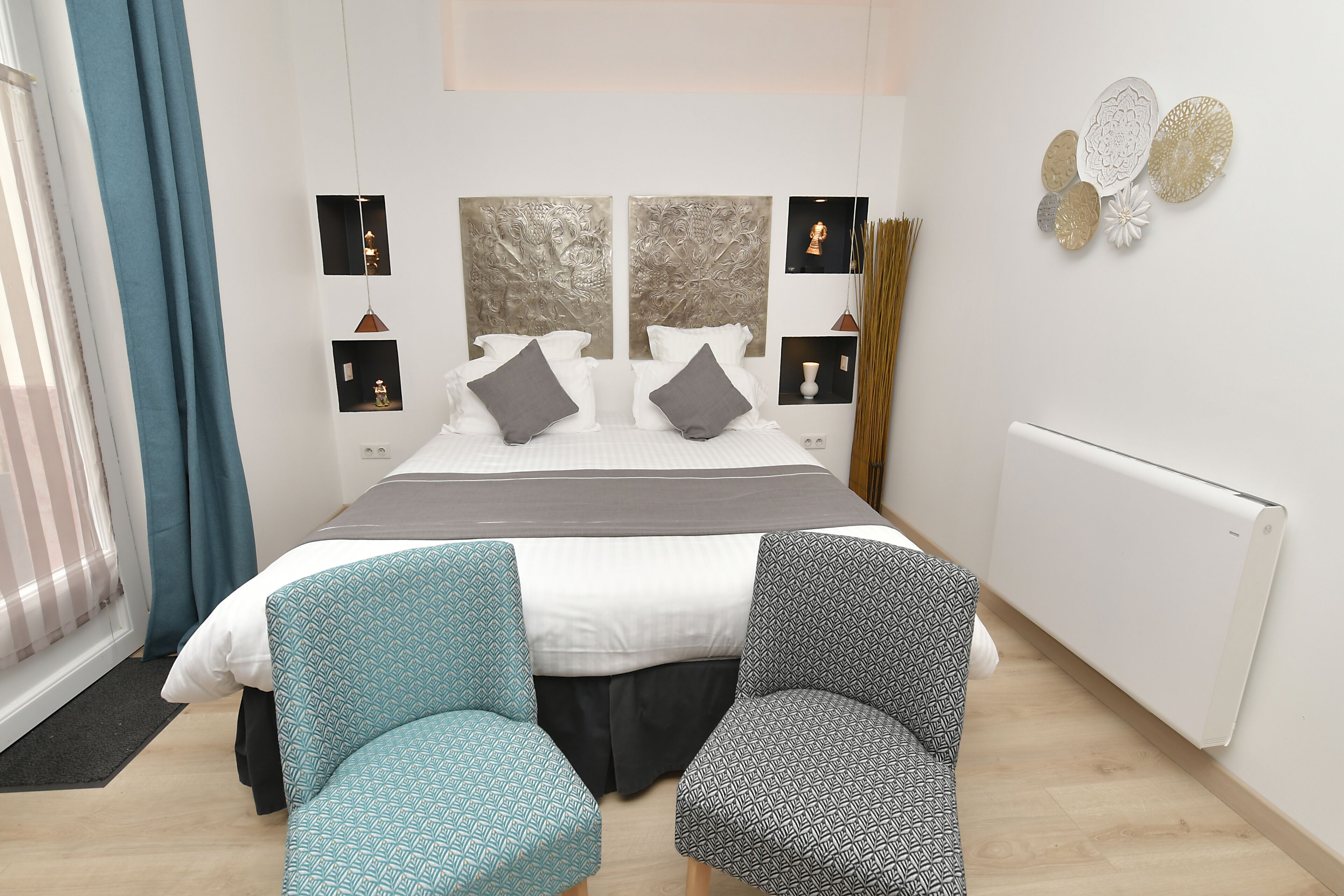 A modern bedroom with a large bed, two bedside tables, and a window with curtains.