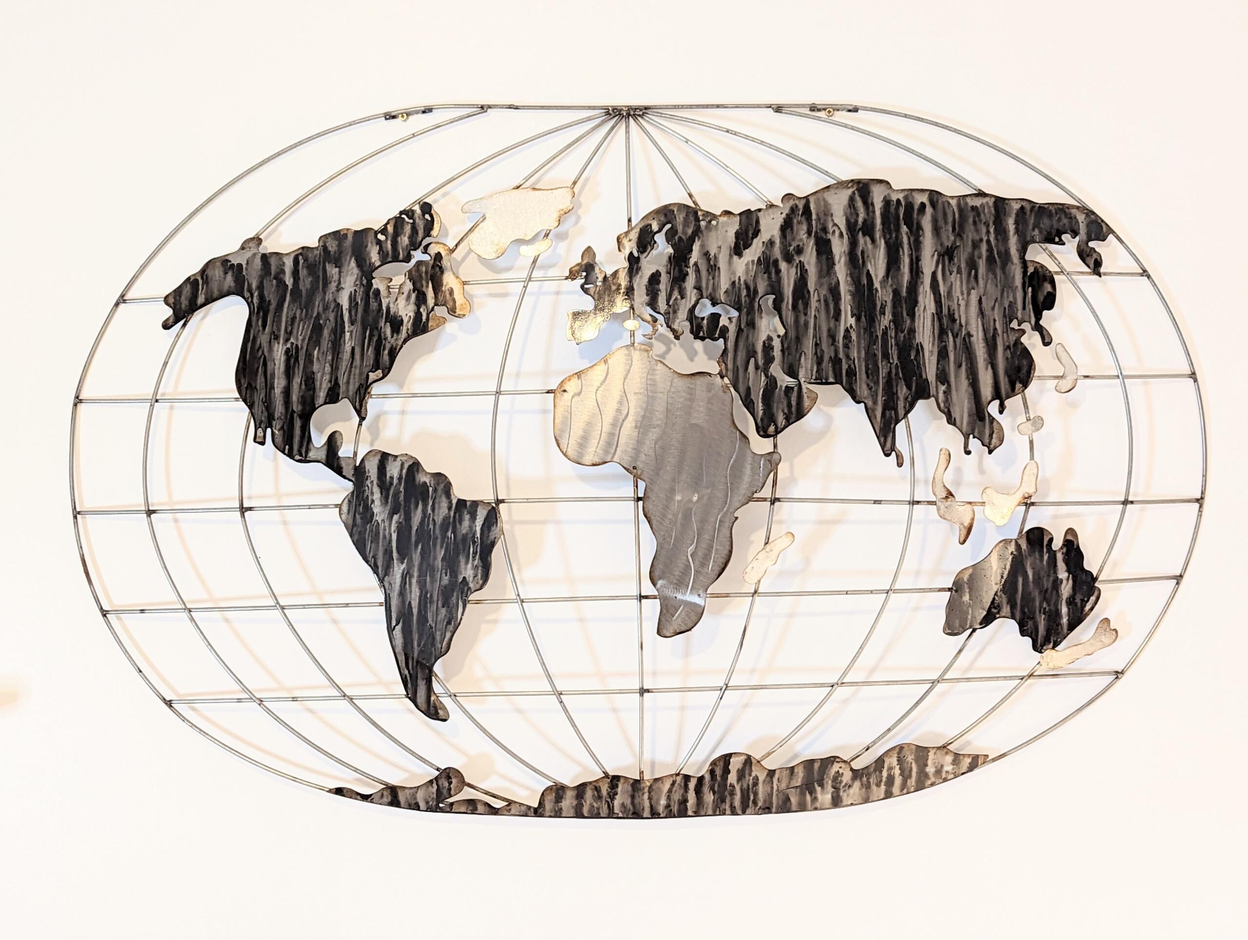 A world map sculpture with a wireframe structure.