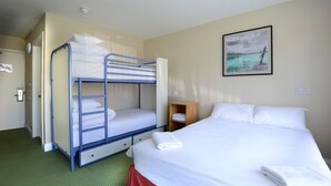 A room with bunk beds, a single bed, a wooden nightstand, and a painting on the wall. - 3 Lakes Hostel (Killarney)
