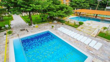 Indoor pool, outdoor pool, pool umbrellas, pool loungers