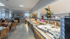 A buffet area with multiple food stations, tables, and chairs.