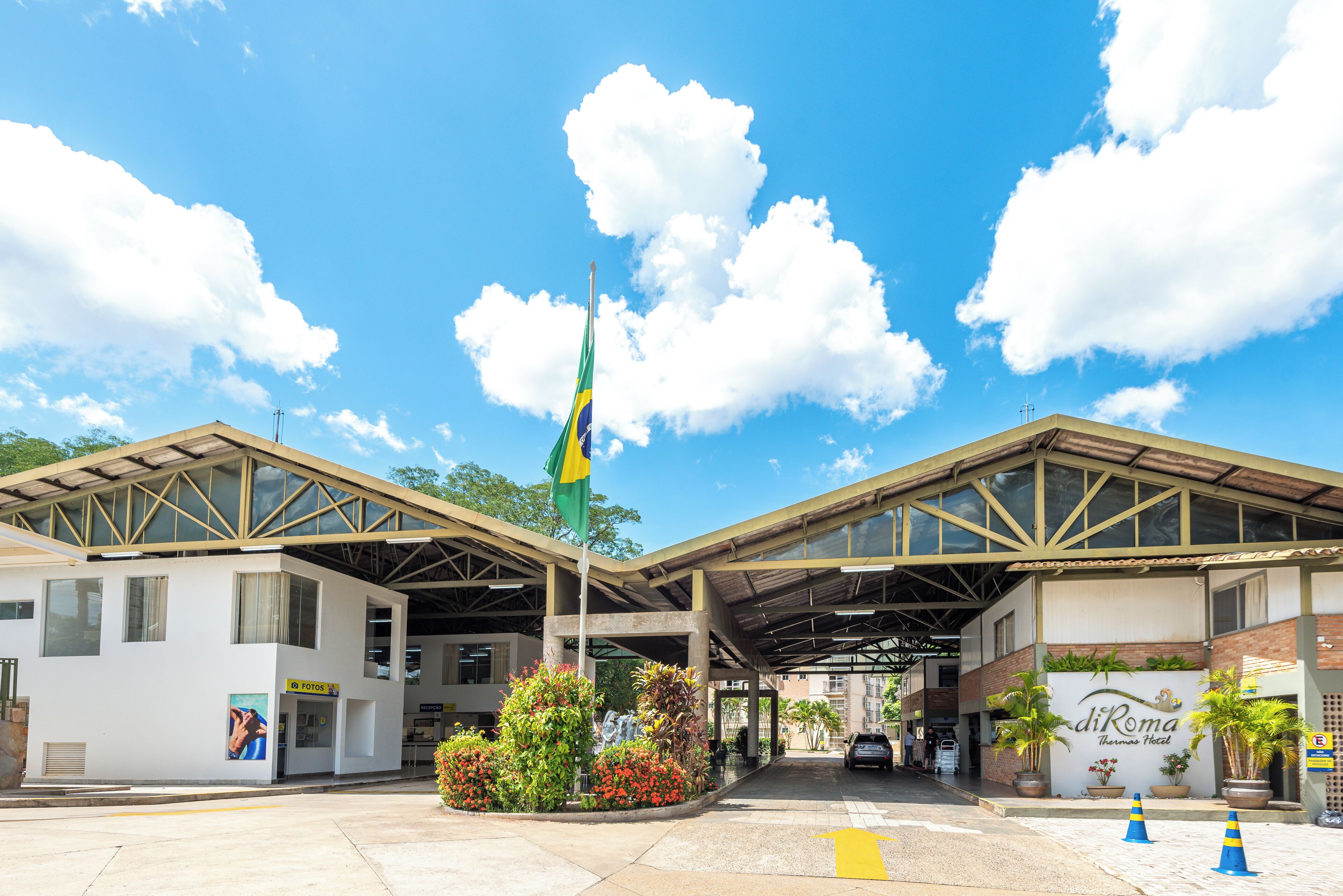 A hotel entrance with a flag, a reception desk, and a sign for the Thomas Hotel.