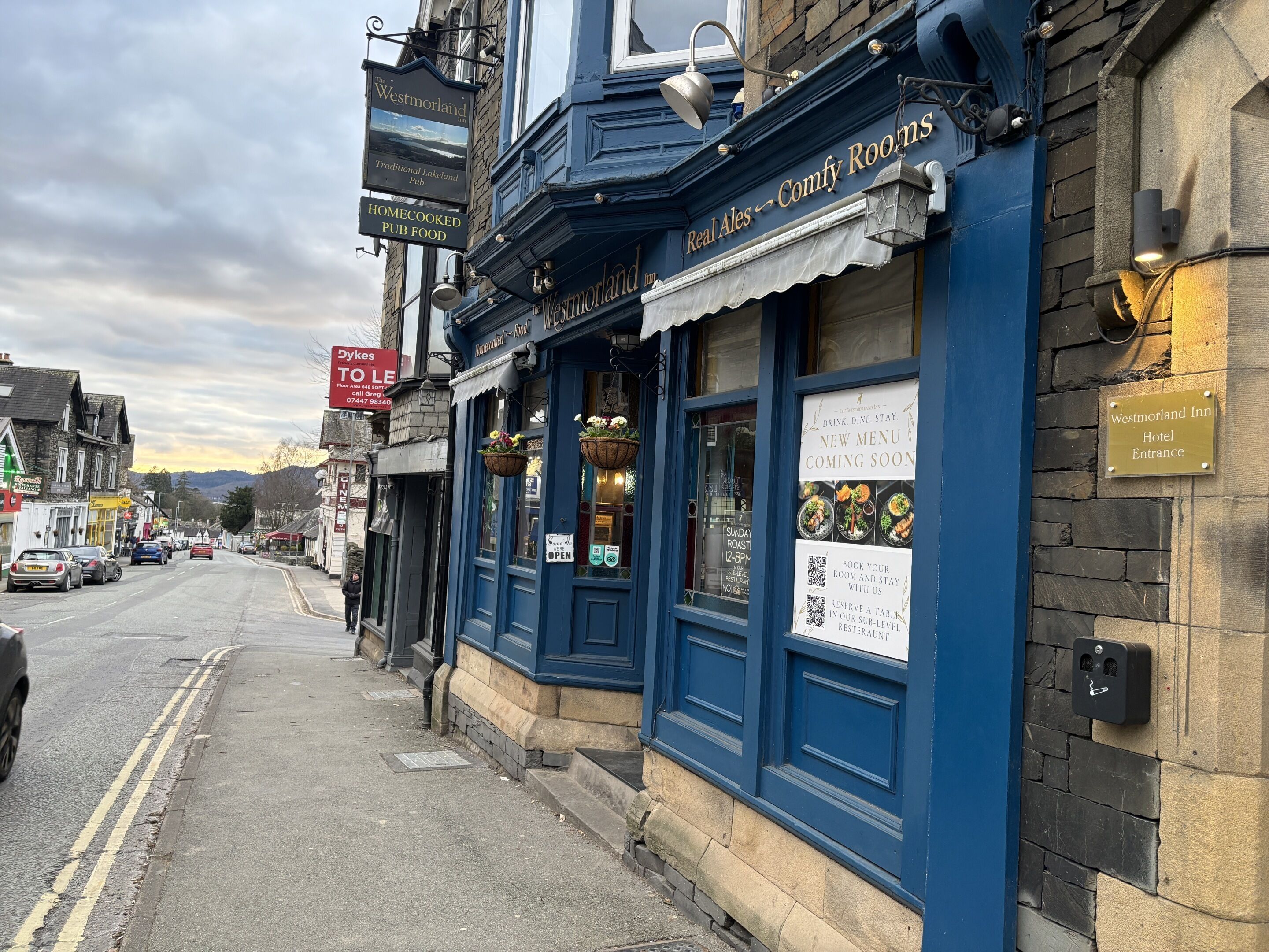 A traditional pub with a sign advertising home-cooked pub food and real ales.