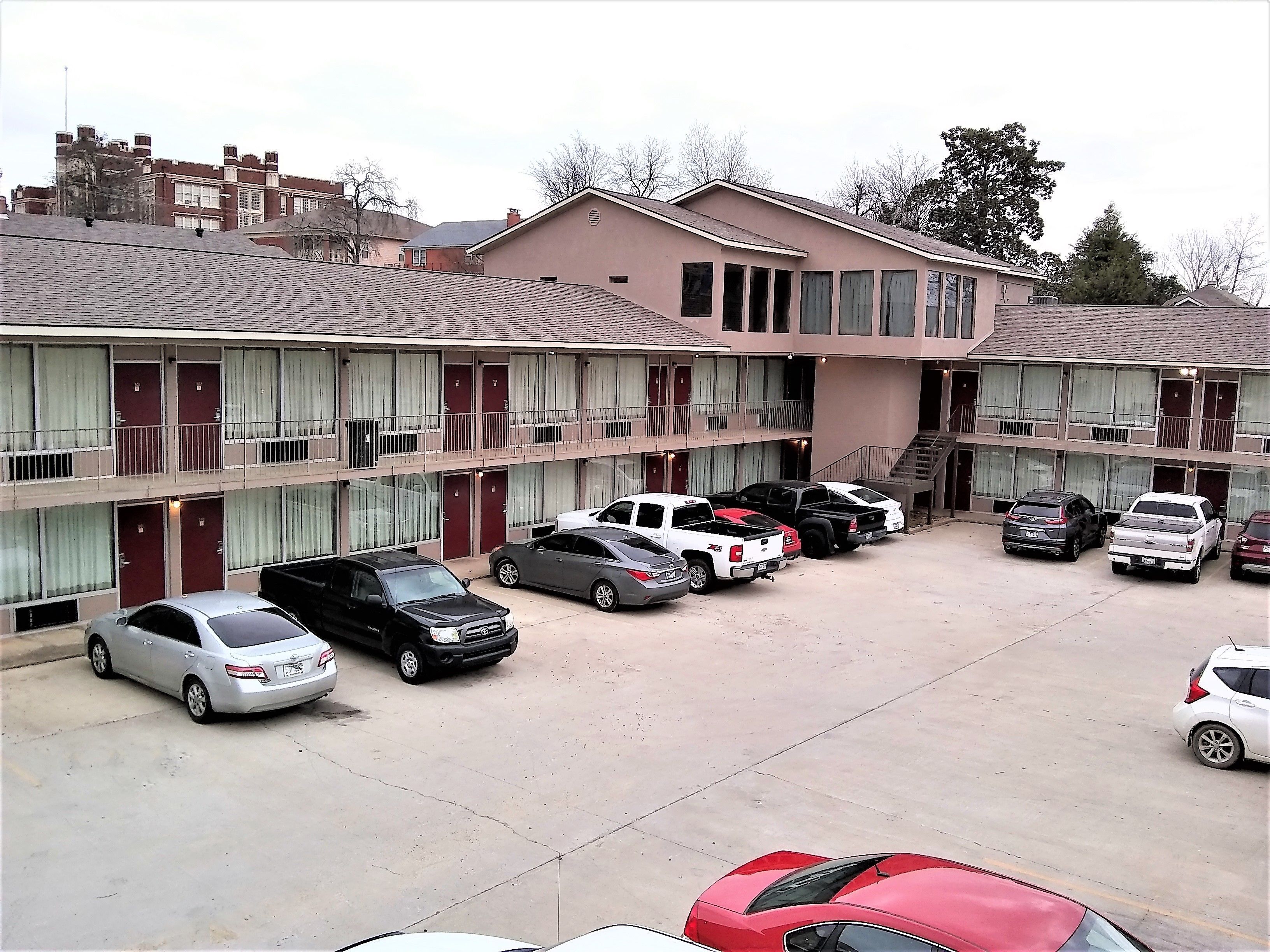 A multi-story motel with a parking lot.