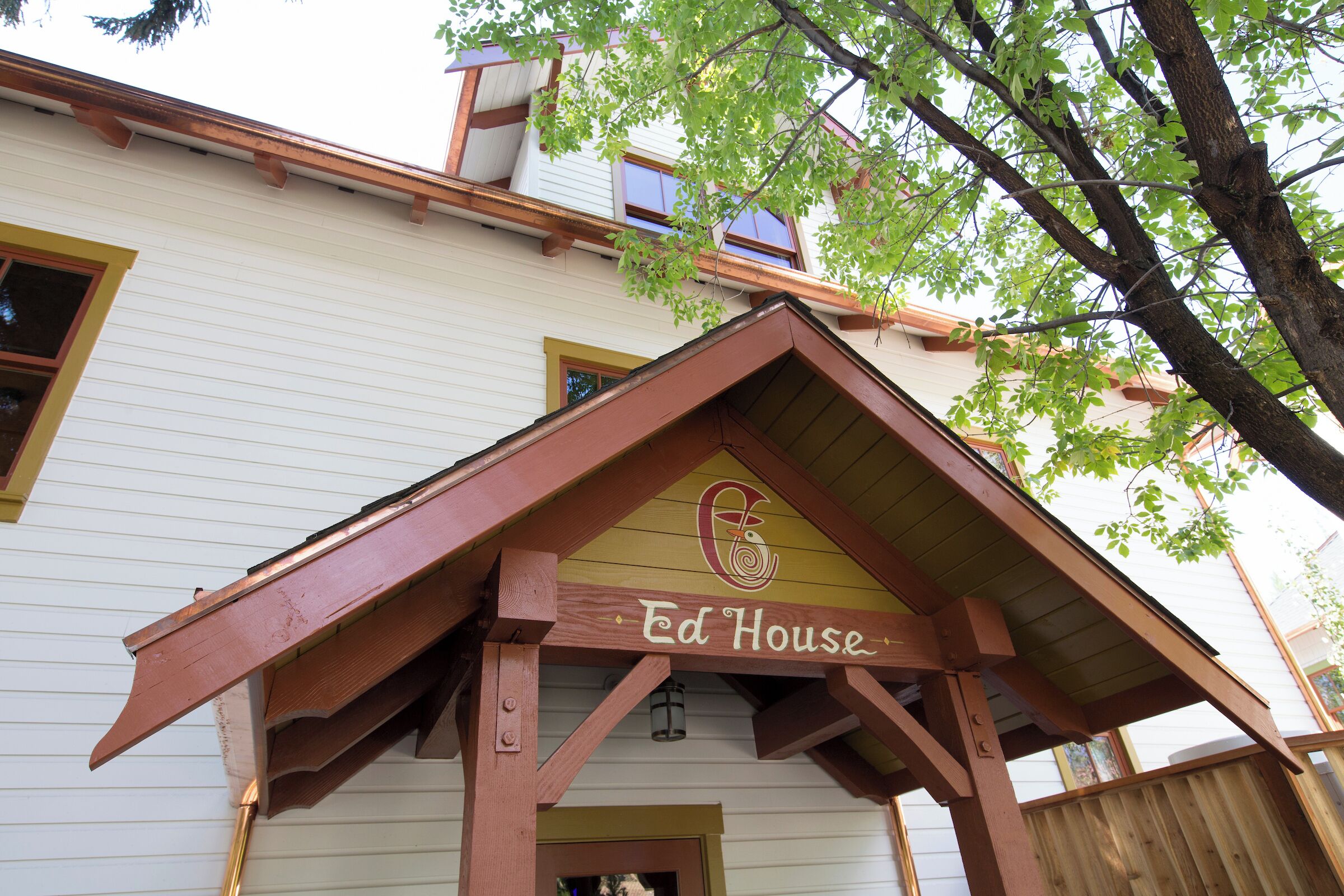 A building with a sign reading 'Ed House' under a wooden structure.