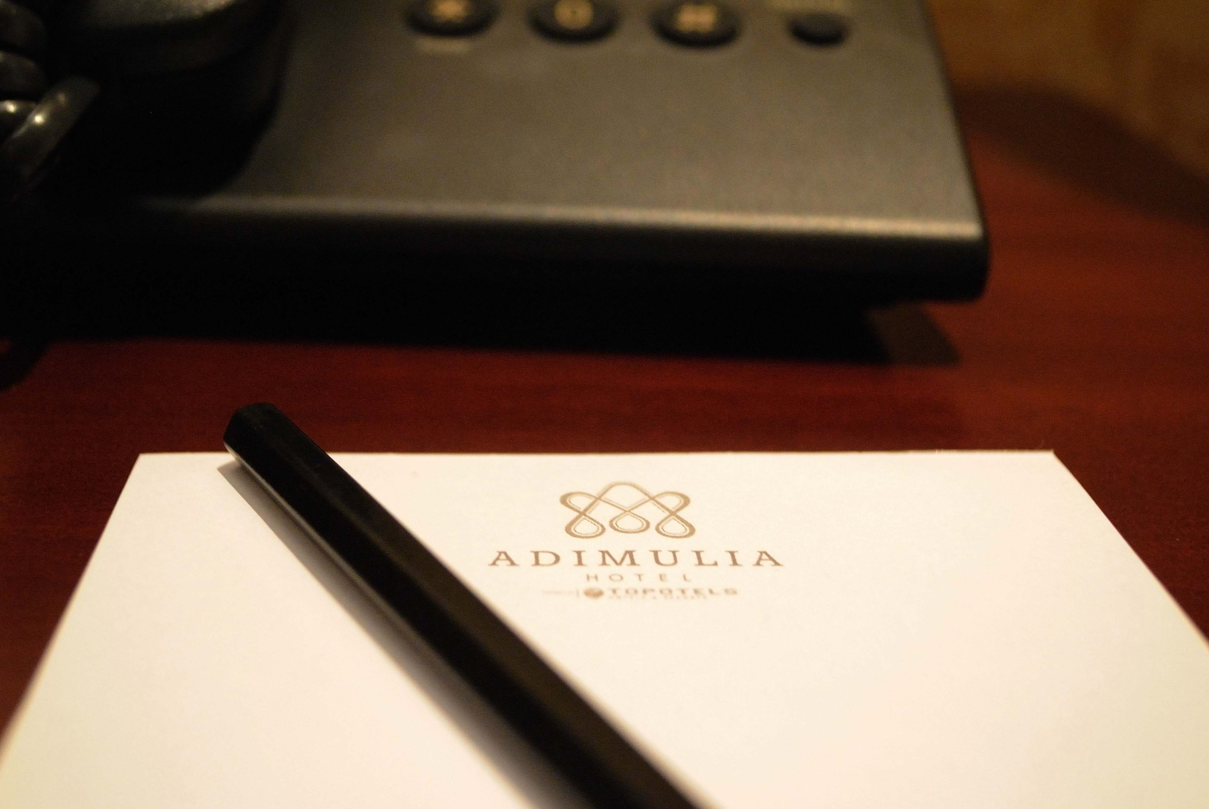 A hotel name card with a pen on it.
