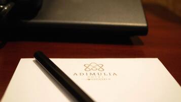A hotel name card with a pen on it.