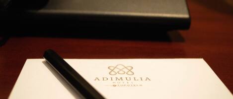 A hotel name card with a pen on it.