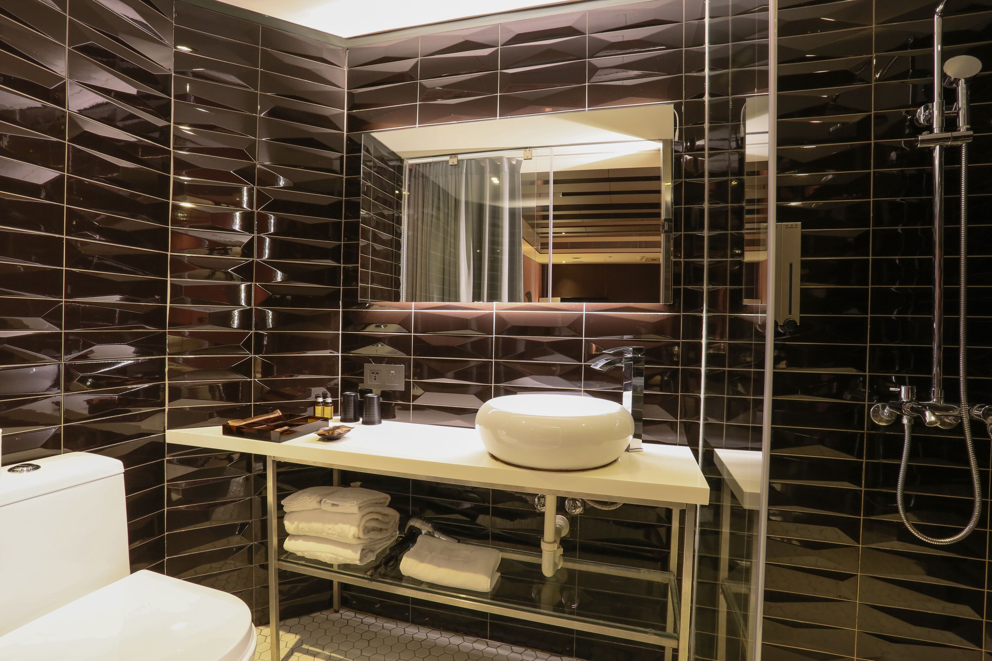 shower, hair dryer, towels, toilet paper