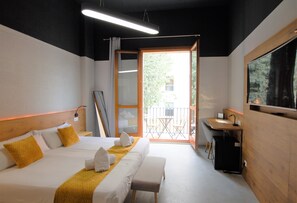 A hotel room with two beds, a desk, and a view of the outdoors. - Brick Palma (Palma de Mallorca)