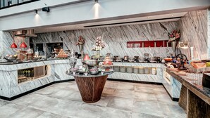 A modern hotel lobby with marble walls, a central wooden island, and a variety of dining ware and decorative items. - THE WAY Dhaka (Dhaka)