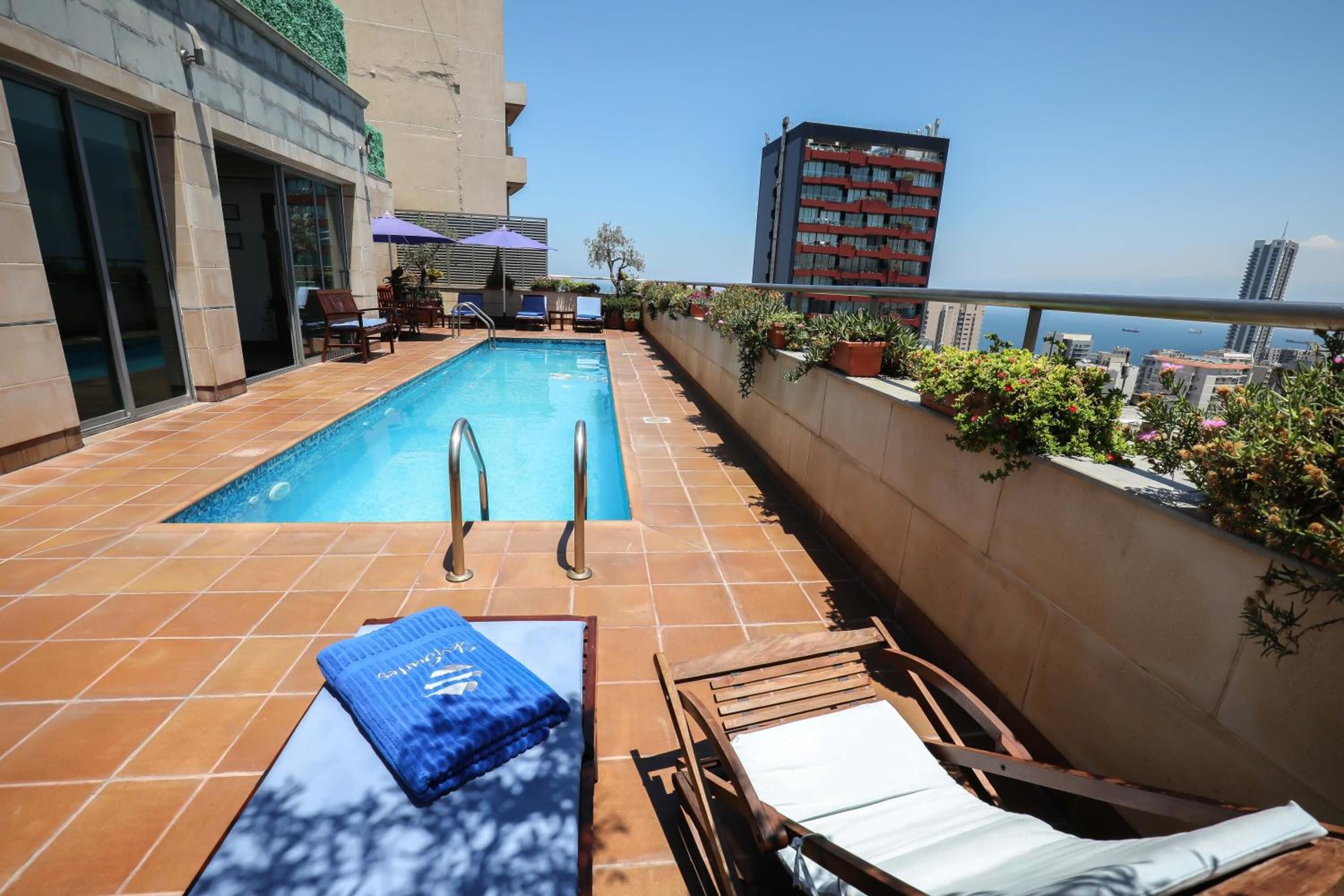 seasonal outdoor pool, pool umbrellas, pool loungers