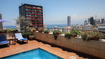 Seasonal outdoor pool, pool umbrellas, pool loungers