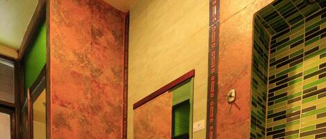 A bathroom with a toilet, sink, and mirror.