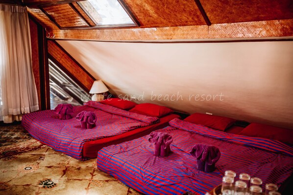 A room with two beds, each with red and blue striped bedding, and a large window with a view of the beach. - White Sand Beach Resort (Ko Chang)