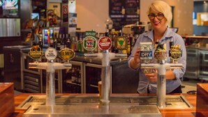 A bar with multiple beer taps, including brands like Cascade, Bulmers, and Carlton Draught.