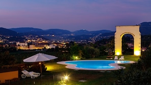 Outdoor pool, a rooftop pool, pool umbrellas, sun loungers
