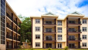 A multi-story residential building with balconies, large windows, and a flat roof. - Praslin Holiday Home (Praslin Island)