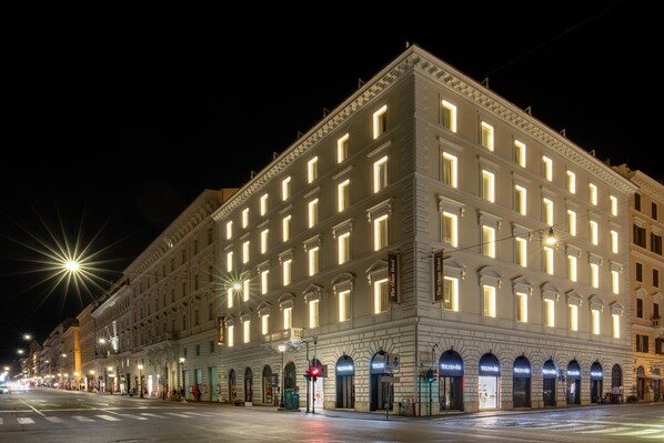 A large, well-lit hotel with multiple floors and a classic architectural style.