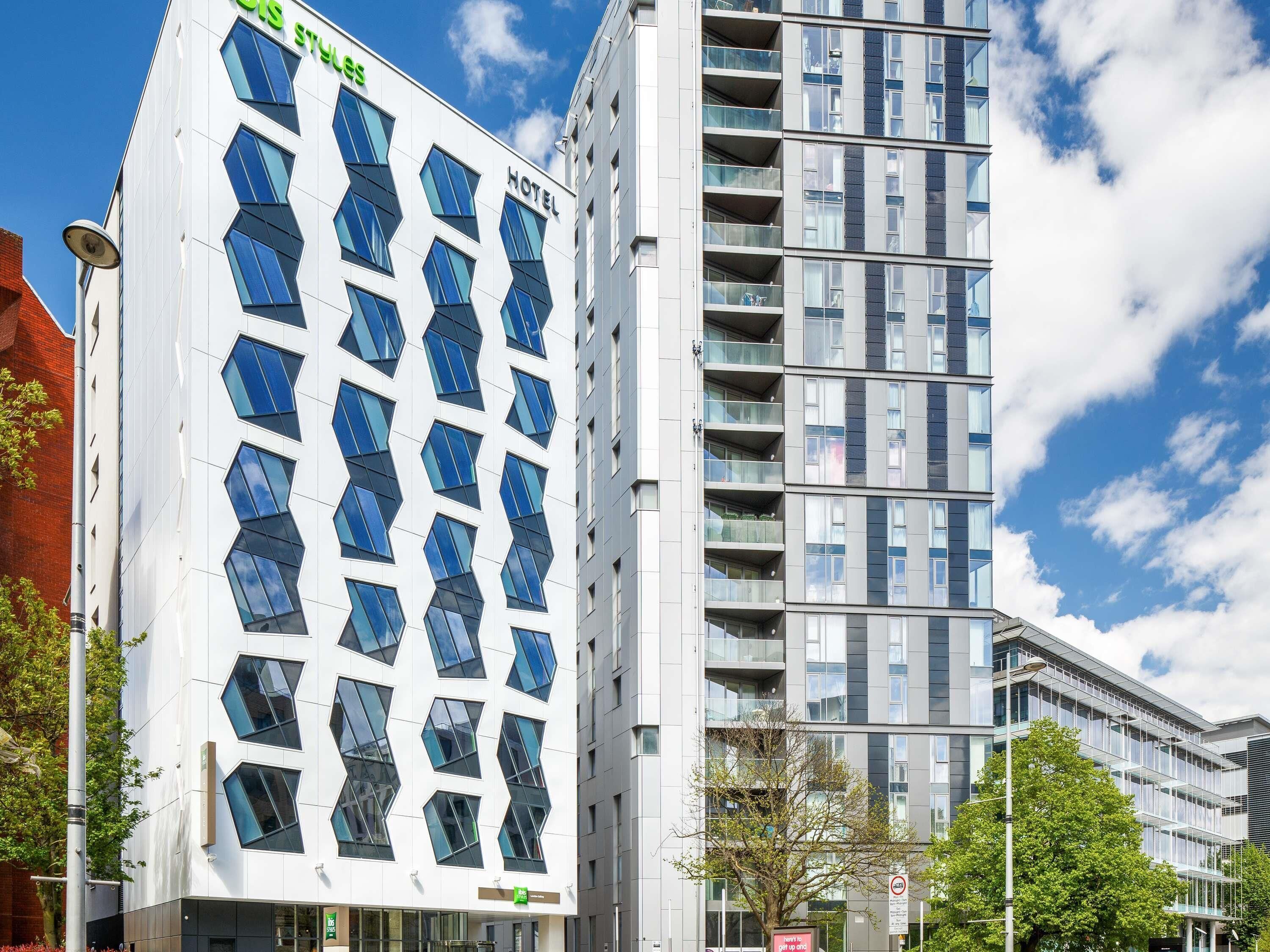 A modern hotel with a distinctive geometric facade and multiple balconies.
