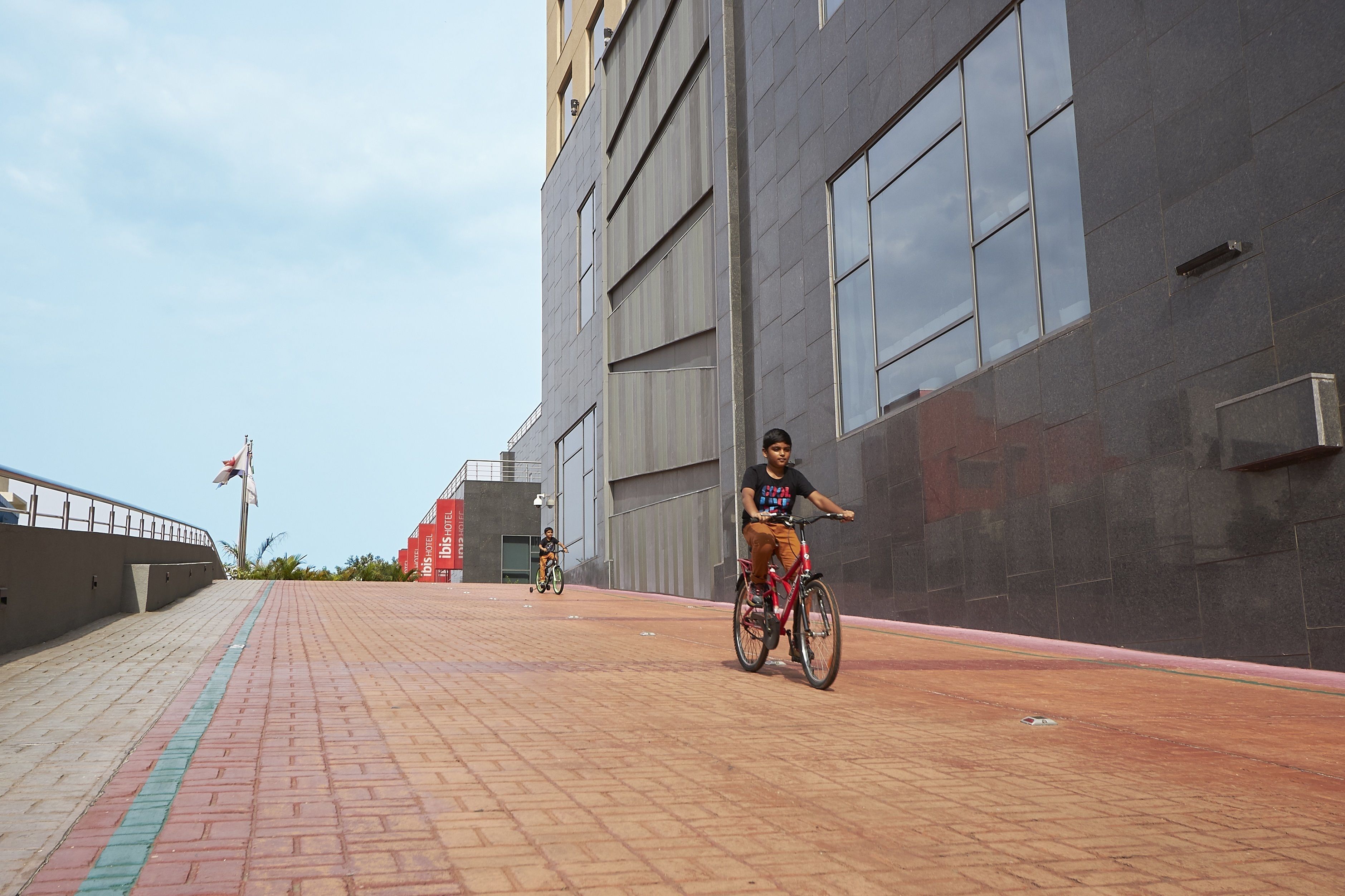 Un camino pavimentado con un ciclista y otro ciclista a lo lejos.