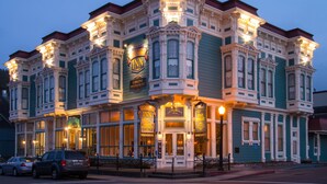 A Victorian-style building with multiple signs for the Victorian Inn and other businesses. - Victorian Inn (Ferndale)