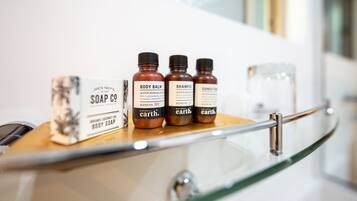 A shelf with bottles of body care products and a box of soap.