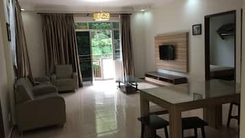 Premier Apartment, 3 Bedrooms | Living room | Flat-screen TV