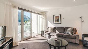 Three Bedroom Apartment | Living area | 32-inch TV with cable channels, DVD player, iPod dock