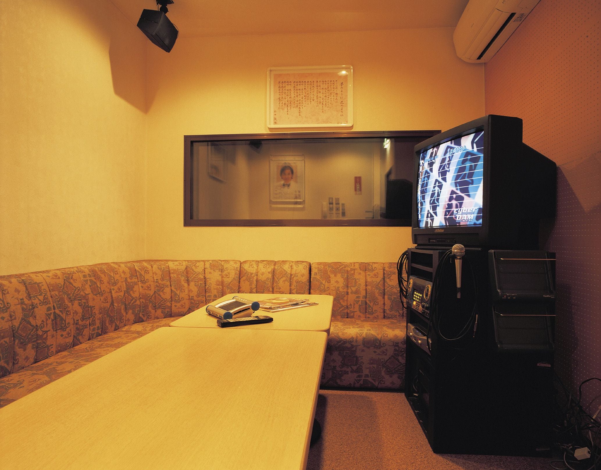 A small room with a sofa, a table, and a television.