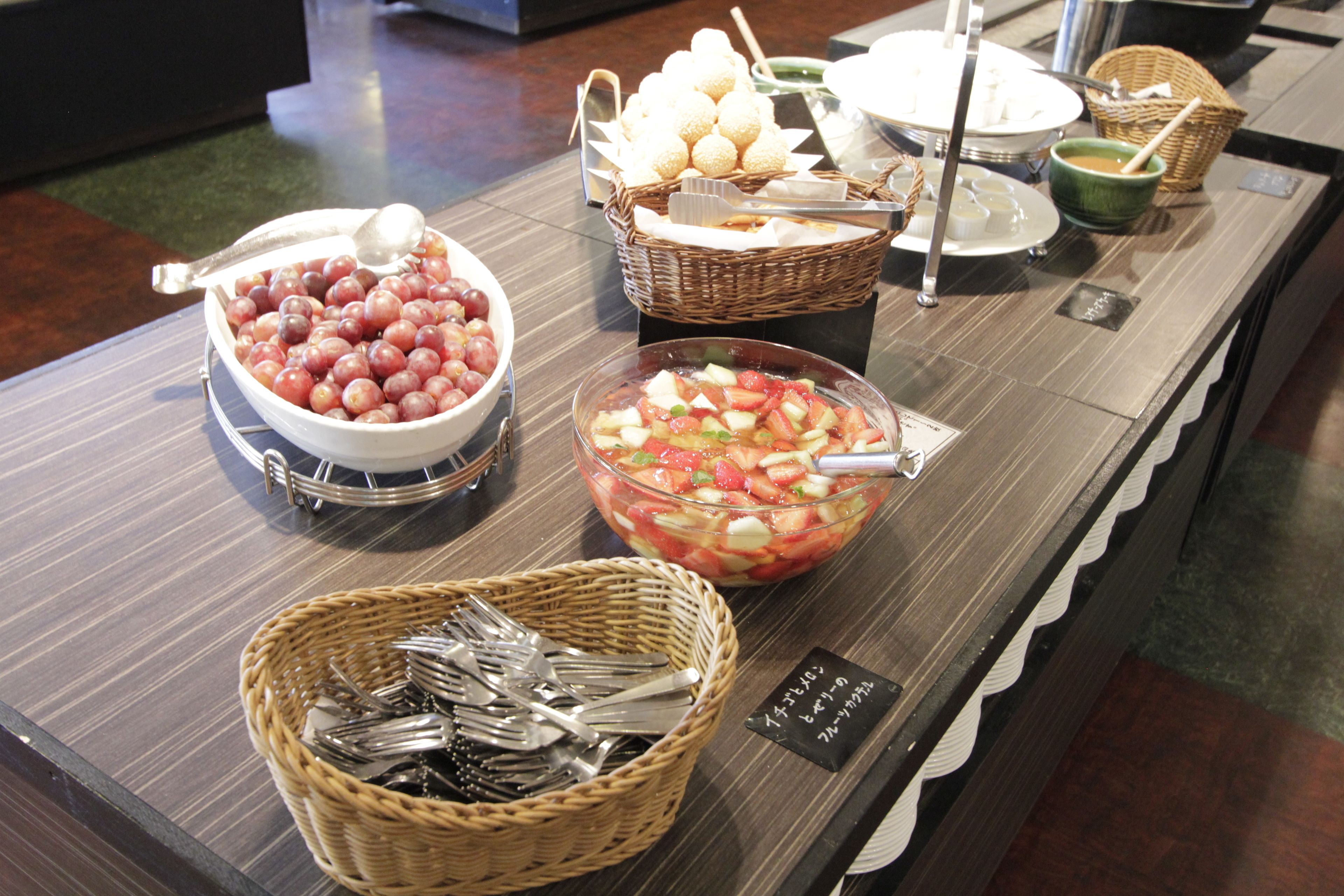 A buffet with various food items and utensils.