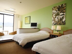A hotel room with two beds, a TV, a desk, a chair, and a view of the outdoors. - Lake Side Hotel & Restaurant Little White Flower (Kyotango)