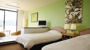 A hotel room with two beds, a TV, a desk, a chair, and a view of the outdoors. - Lake Side Hotel & Restaurant Little White Flower (Kyotango)