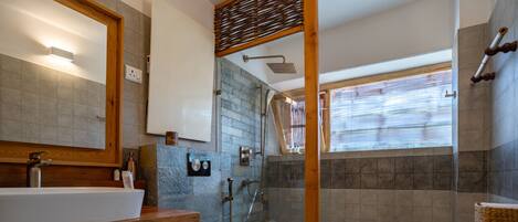 A modern bathroom with a large sink, toilet, and shower area.