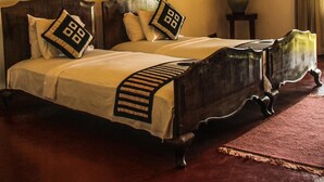 A traditional bed with a wooden frame and a headboard, accompanied by matching pillows and a bedspread.