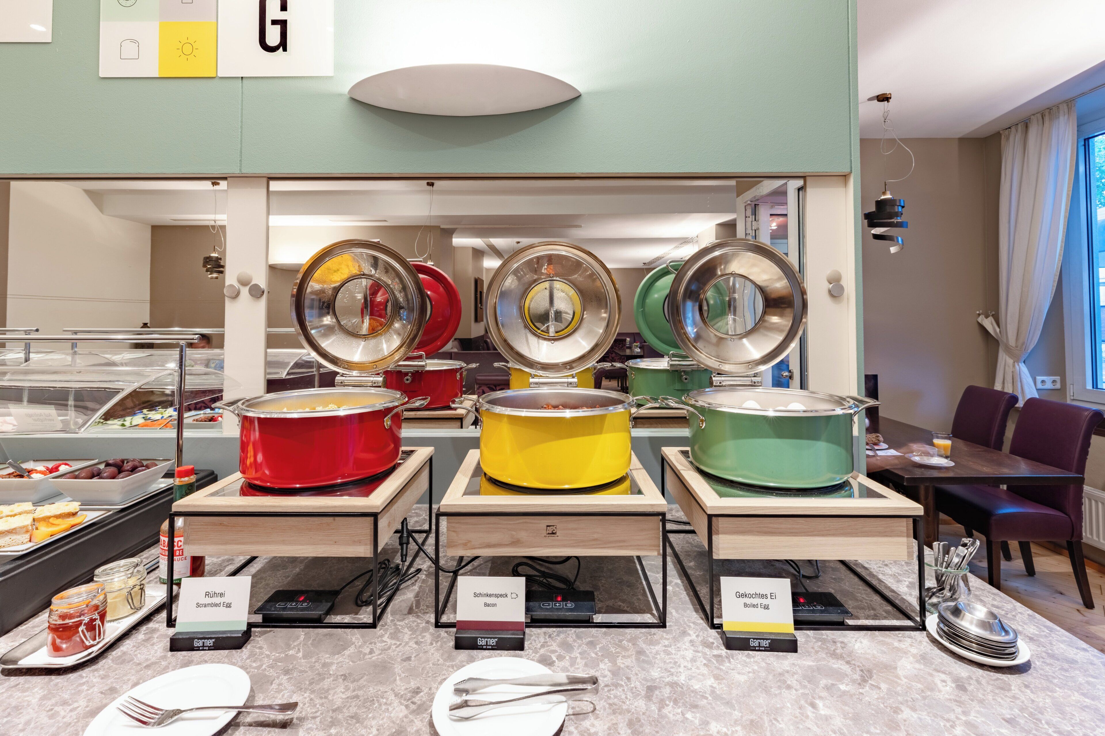 A buffet area with various dishes and cooking stations.