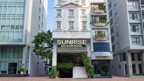 A hotel with a classic facade, a prominent entrance, and a staircase leading to the entrance. - Sunrise Central Hotel (Ho Chi Minh City)
