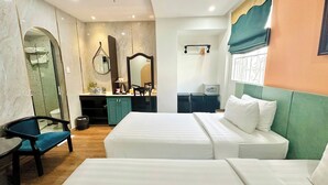 A hotel room with two beds, a desk, a chair, a mirror, and a window with curtains. - Sunrise Central Hotel (Ho Chi Minh City)