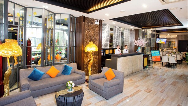 A modern hotel lobby with sofas, a reception desk, and a dining area. - Sunrise Central Hotel (Ho Chi Minh City)