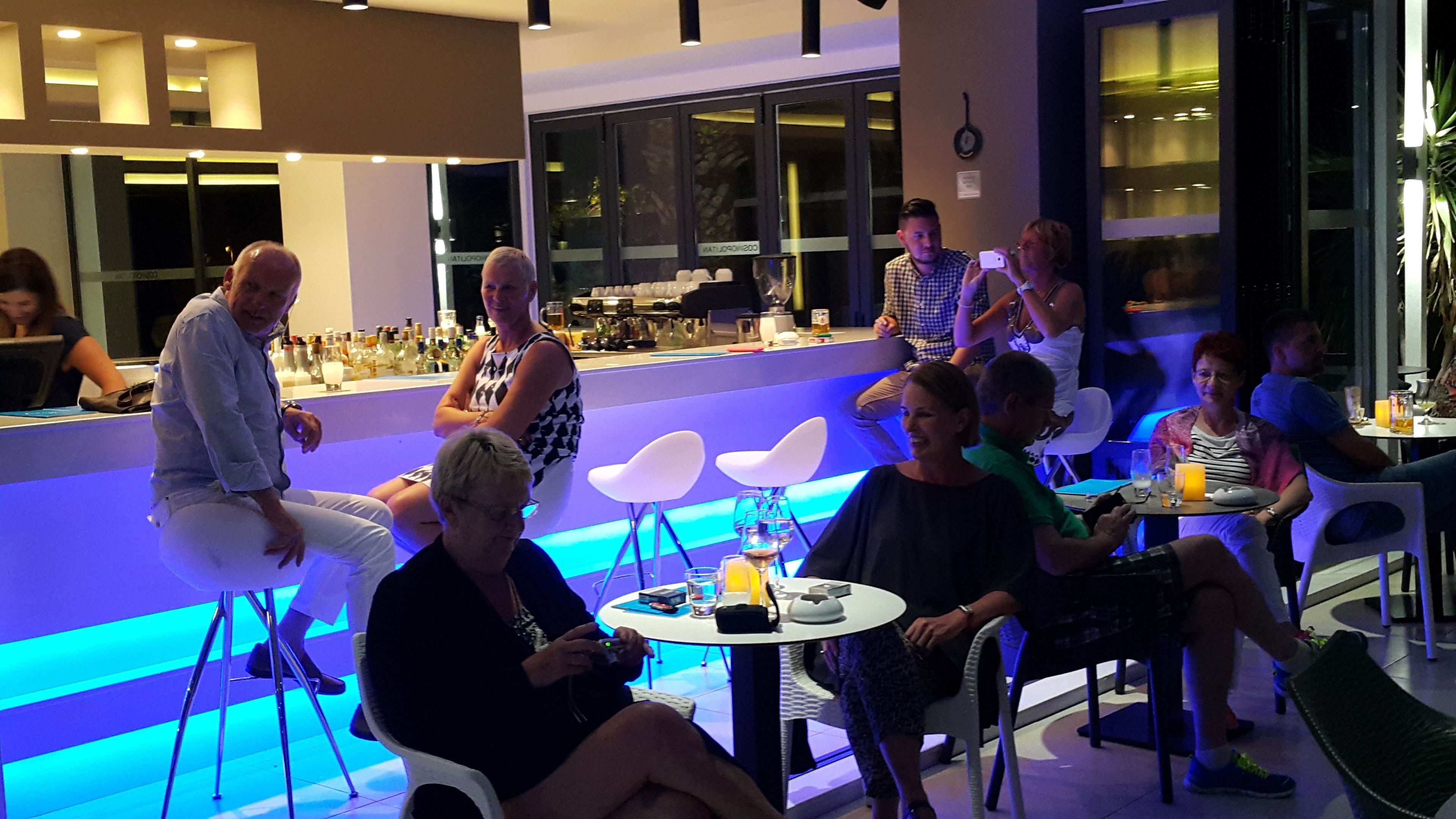 A modern bar area with seating and a bar counter.