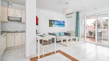 A modern apartment with a kitchen, dining area, and living room.